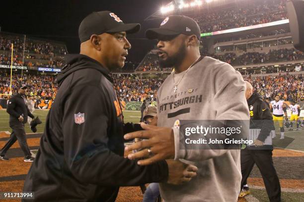 Head Coach Marvin Lewis of the Cincinnati Bengals shares a moment at midfield with Head Coach Mike Tomlin of the Pittsburgh Steelers after their game...