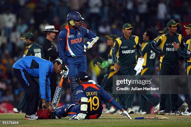 Raul Dravid is helped after falling during his dismissal during The ICC Champions Trophy Group A Match between India and Pakistan on September 26,...