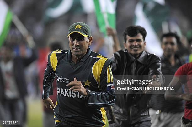 Pakistan Captain younus Khan is chased by supporters invading the pitch to celebrate Pakistan victory over India on September 26, 2009 at the end of...