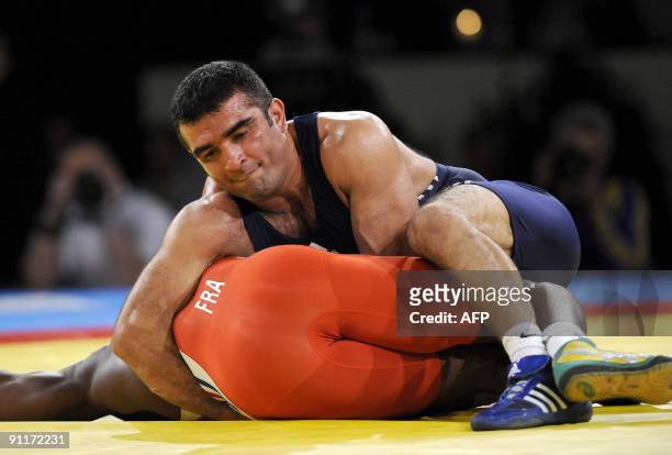 Melonin Noumonvie of France is held by Nazmi Avluca of Turkey during their 84 kg gold medal Greco-Roman match at the World Wrestling Championships...