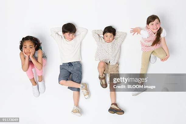 children, view from above, studio shot - supino foto e immagini stock