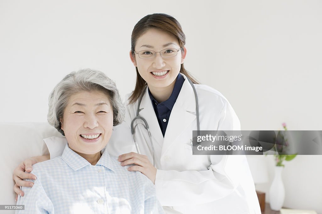 Young female doctor and patient, smiling, portrait