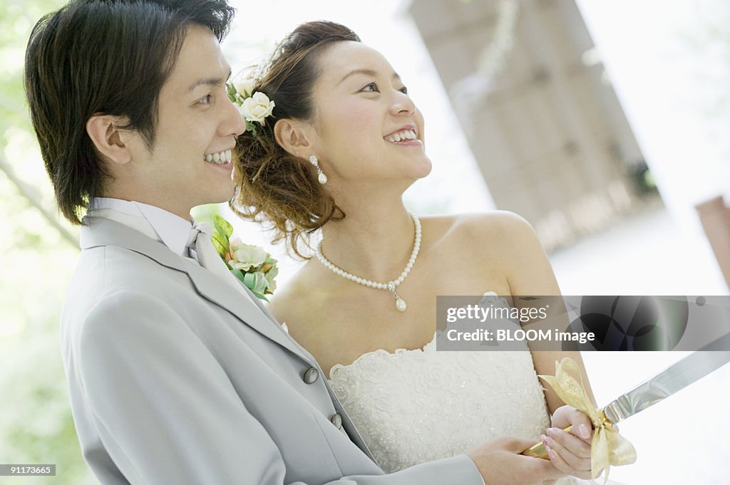 Bride and groom cutting wedding cake