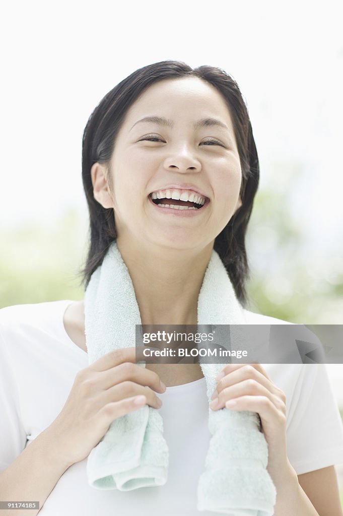 Woman smiling with towel around neck