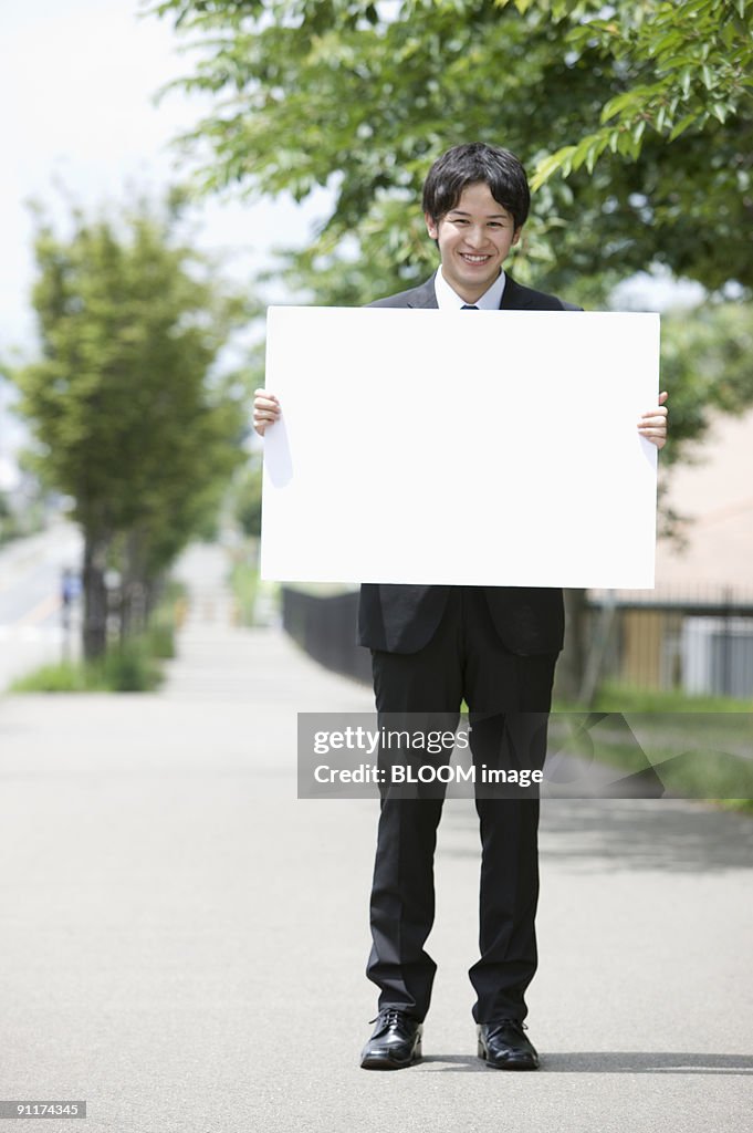 Businessman holding whiteboard