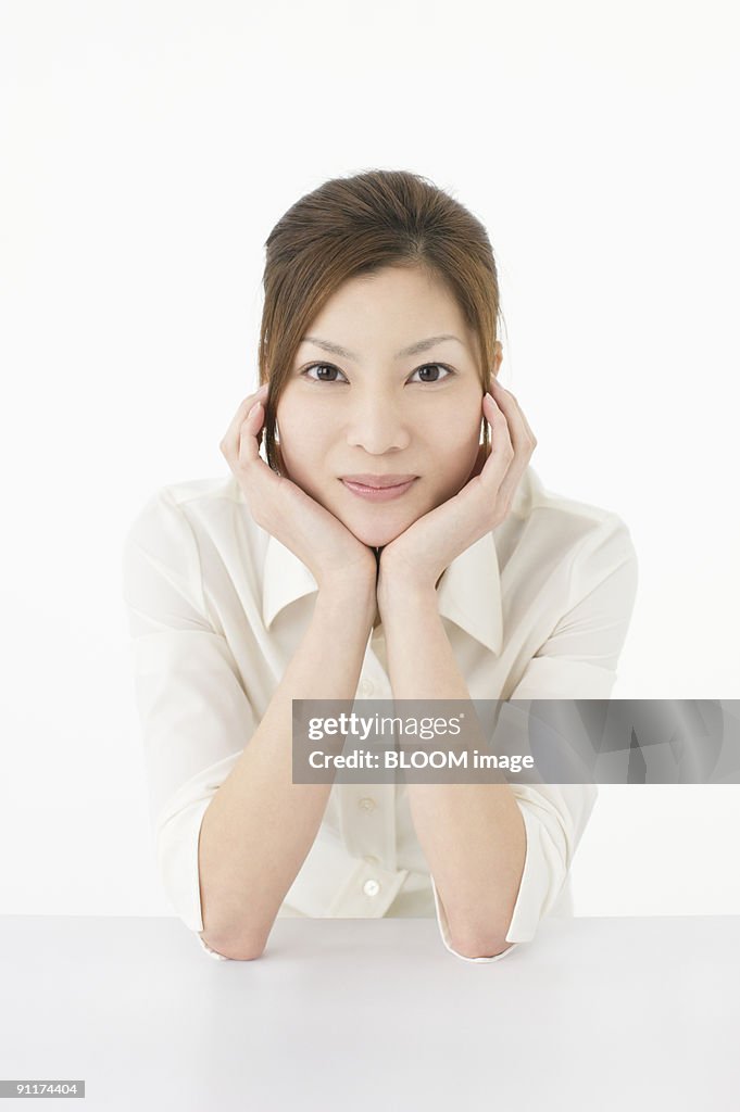 Woman resting chin on hands