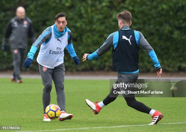 Mesut Ozil and Mathieu Debuchy of Arsenal during a training session at London Colney on January 29, 2018 in St Albans, England.