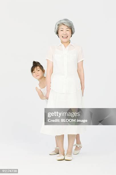 girl with grandmother - front on portrait older full body foto e immagini stock