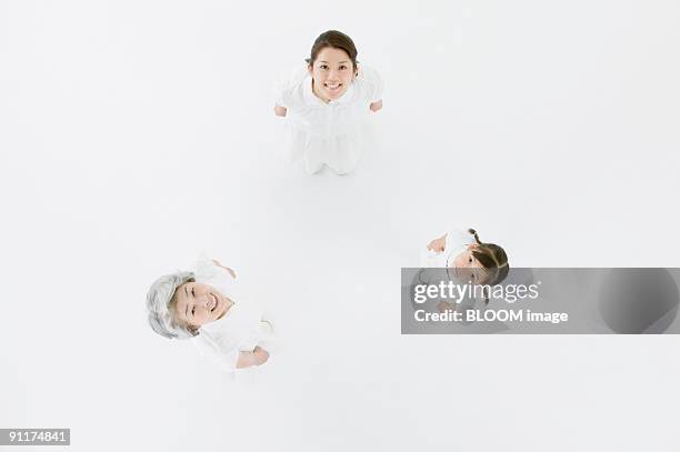 grandmother, mother and granddaughter, view from above - grootmoeder witte achtergrond stockfoto's en -beelden