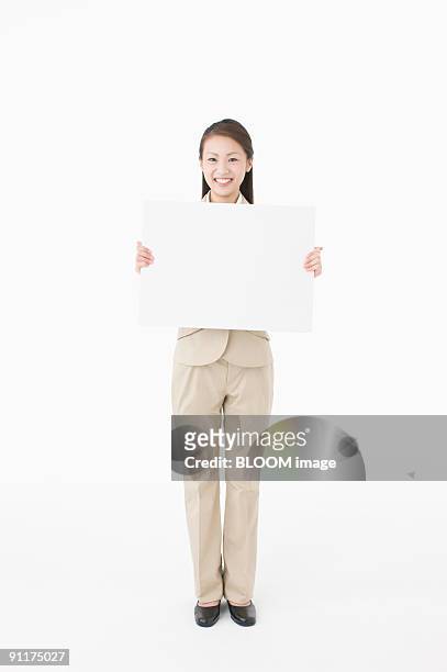 businesswoman holding whiteboard, smiling - ボード　持つ　女性 ストックフォトと画像