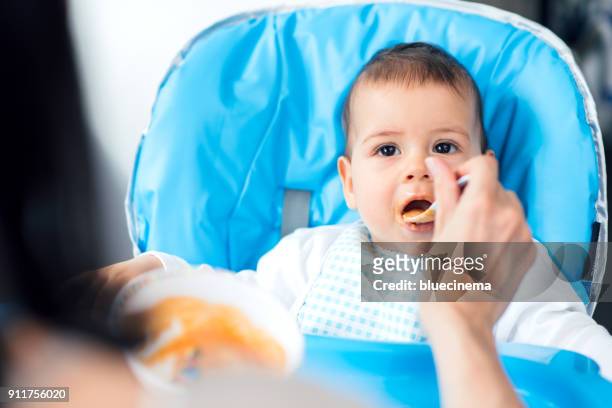 mother feeding her baby - moving up to seated position stock pictures, royalty-free photos & images