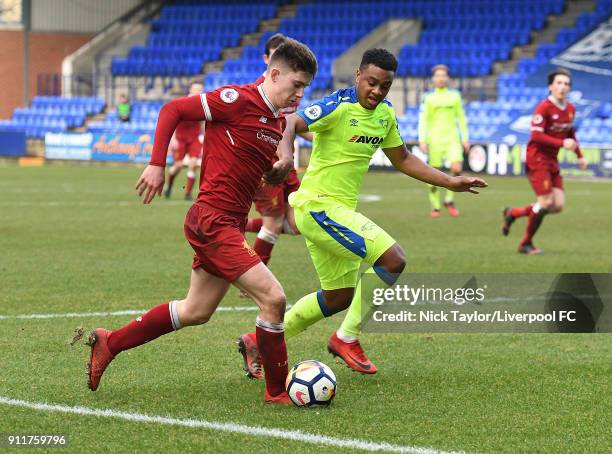 Ben Woodburn of Liverpool is taken out by Kyron Stodana of Derby County during the Premier League 2 match between Liverpool and Derby County at...