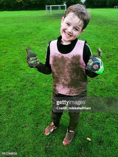 real life moment when boy gets covered in mud after soccer practice - caught in the act stock pictures, royalty-free photos & images