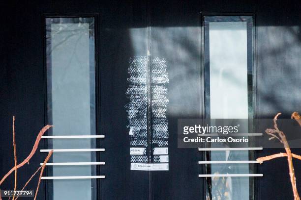 Police seals on the front door of the Sherman home Friday morning. Toronto police released the home back to the Sherman family Friday morning after...