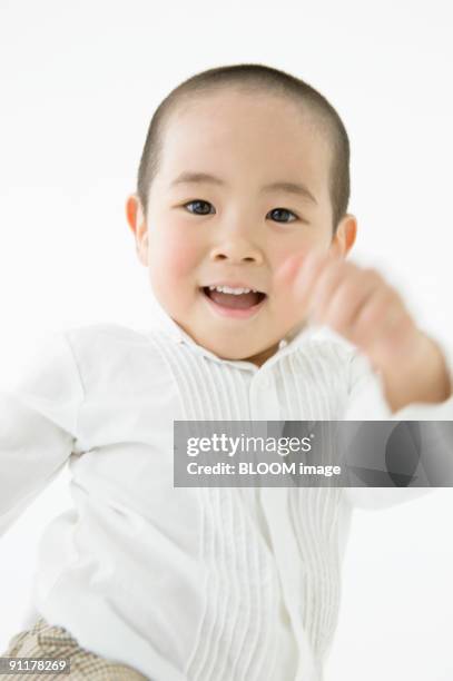 boy, studio shot - twist arm stock pictures, royalty-free photos & images