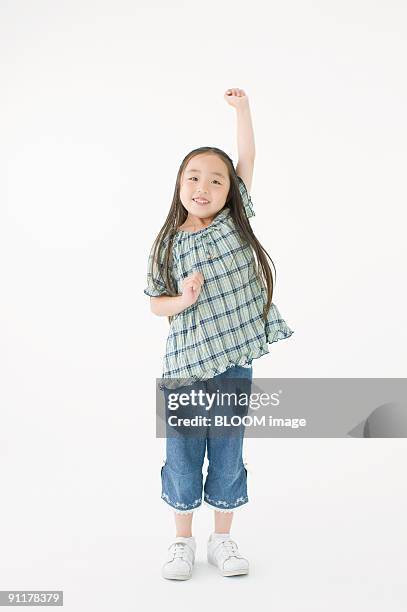 girl raising fist, portrait, studio shot - kid studio shot stock pictures, royalty-free photos & images