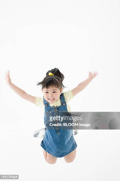 girl jumping, arms raised - girl jump studio stock pictures, royalty-free photos & images