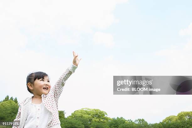 girl raising hand - only kids at sky stock pictures, royalty-free photos & images