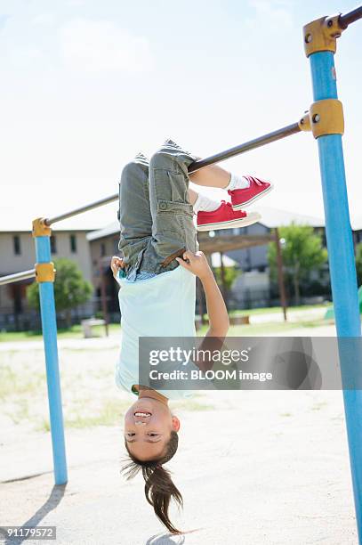 girl playing with horizontal bar - hemming park stock pictures, royalty-free photos & images