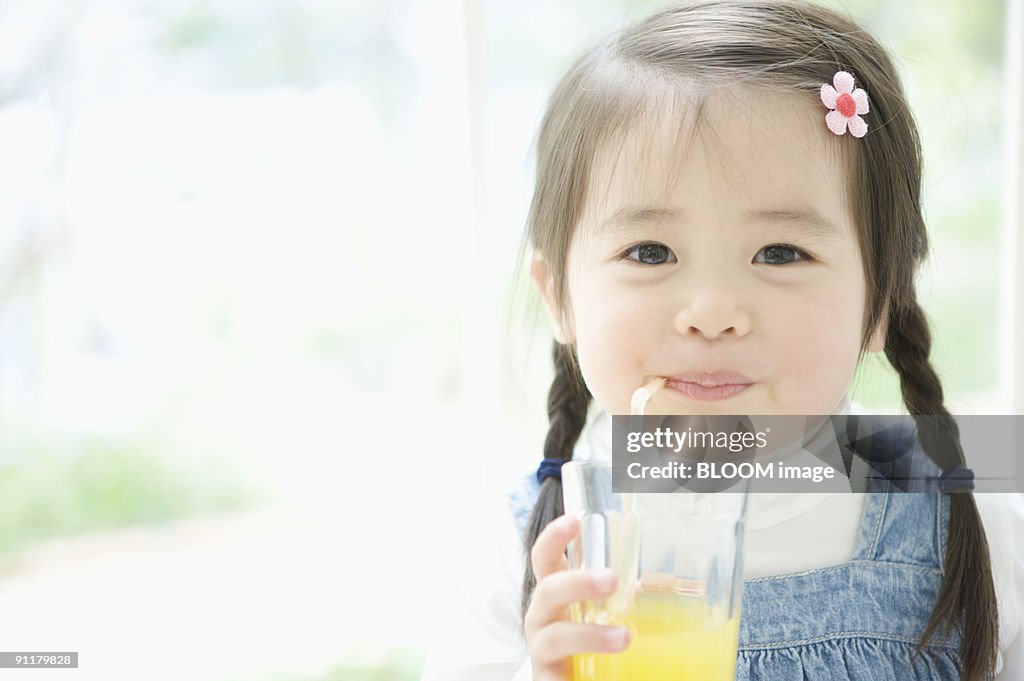 Girl having orange juice