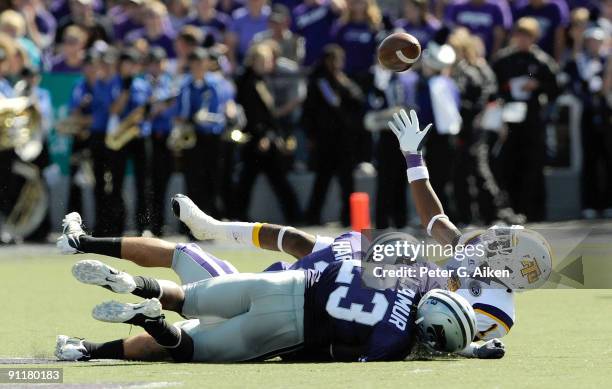 Wide receiver Antonio Robinson of the Tennessee Tech Golden Eagles reaches up from the ground to make a first down catch in front of defenders...