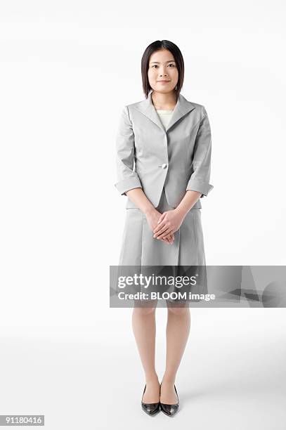 businesswoman, portrait, studio shot - person standing front on inside stock pictures, royalty-free photos & images