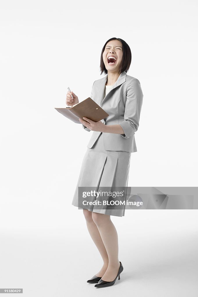 Businesswoman smiling, studio shot