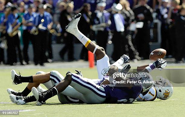 Wide receiver Antonio Robinson of the Tennessee Tech Golden Eagles reaches up from the ground to make a first down catch in front of defenders...