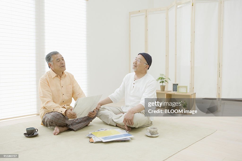 Senior men listening to music with eyes closed