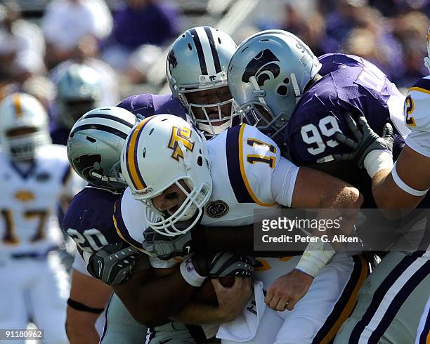 Defenders Daniel Calvin and Courtney Herndon of the Kansas State Wildcats sack quarterback Lee Sweeney of the Tennessee Tech Golden Eagles during the...