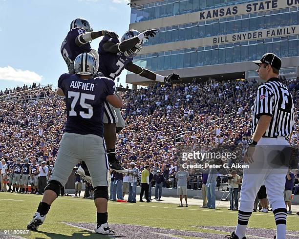 Running back Daniel Thomas of the Kansas State Wildcats celebrates after scoring on a one yard touchdown run with teammates Lamark Brown and Clyde...