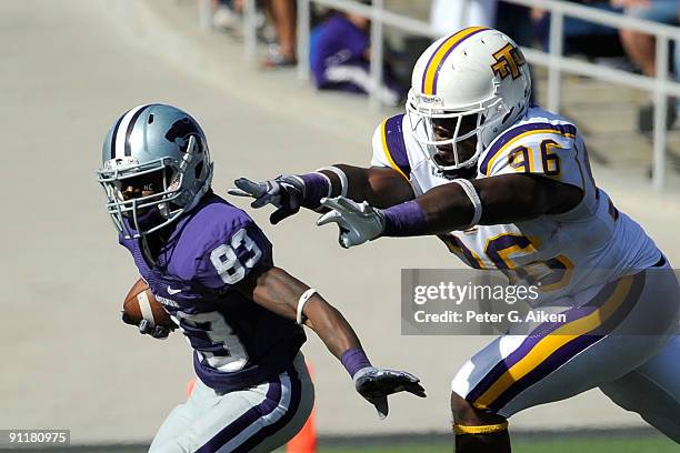 Wide receiver Brandon Banks of the Kansas State Wildcats rushes up field during a punt return under pressure form defender Dedrick Miley of the...