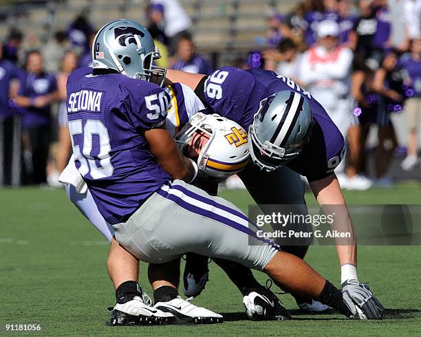 Defenders Hansen Sekona and Payton Kirk of the Kansas State Wildcats sack quarterback Tre Lamb of the Tennessee Tech Golden Eagles during the fourth...