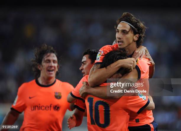 Zlatan Ibrahimovic of Barcelona celebrates with Lionel Messi after scoring his team's opening goal during the La Liga match between Malaga and...