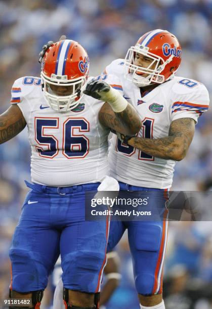 Tight end Aaron Hernandez celebrates his touchdown with teammate Maurkice Pouncey in the first quarter of the game against the Kentucky Wildcats at...