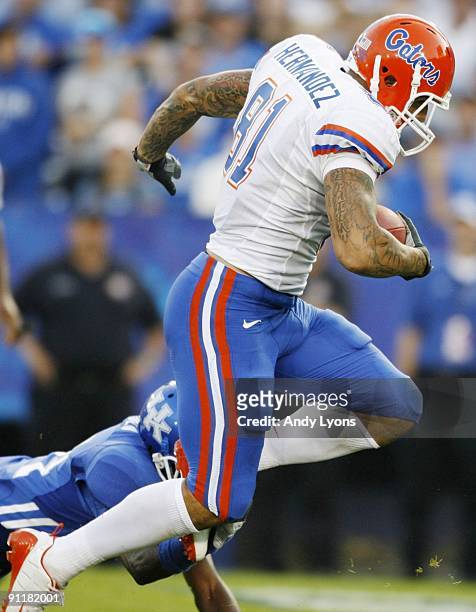 Tight end Aaron Hernandez carries the ball for a touchdown after completing a 44-yard pass in the first quarter of the game at Commonwealth Stadium...