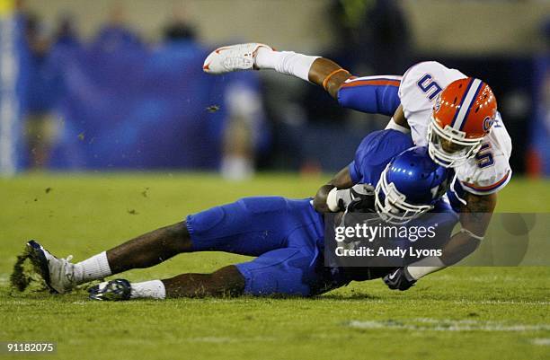 Center back Joe Haden of the Florida Gators tackles wide receiver Chris Matthews of the Kentucky Wildcats during the third quarter of the game at...