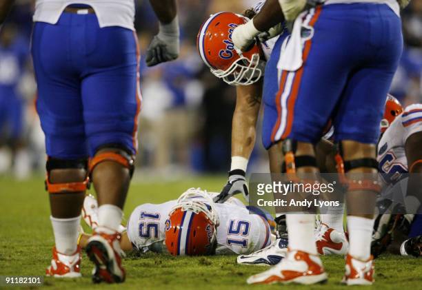 Quarterback Tim Tebow of the Florida Gators lays on the ground after being sacked by Taylor Wyndham of the Kentucky Wildcats during the third quarter...