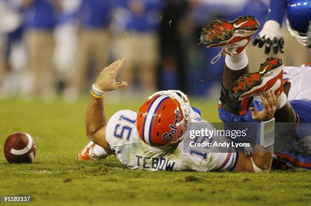 Quarterback Tim Tebow of the Florida Gators lays on the ground after being sacked by Taylor Wyndham of the Kentucky Wildcats during the third quarter...