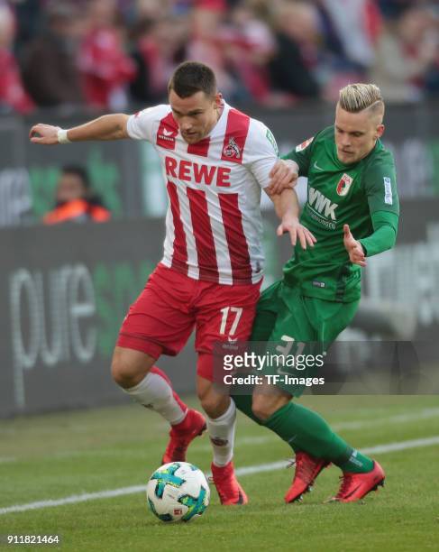Christian Clemens of Koeln and Philipp Max of Augsburg battle for the ball during the Bundesliga match between 1 FC Koeln and FC Augsburg at...