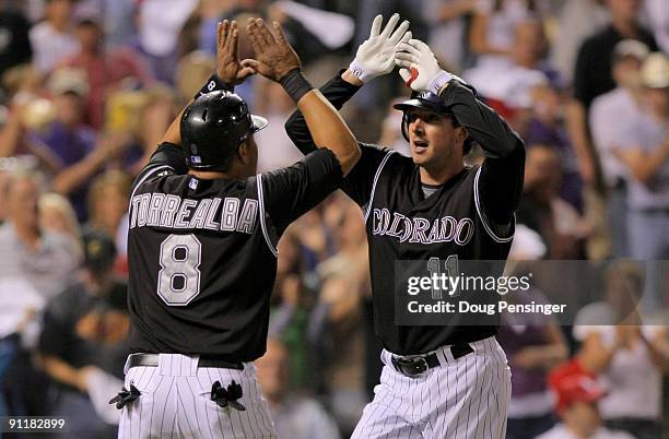 Brad Hawpe of the Colorado Rockies is welcomed home by Yorvit Torrealba who scored on Hawpe's two run homer off of starting pitcher Adam Wainright of...