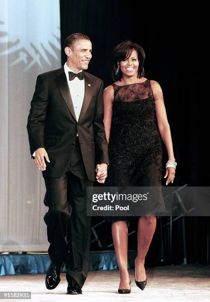 President Barack Obama and the first lady Michelle Obama attend the Congressional Black Caucus Foundation's Annual Phoenix Awards Dinner at the...