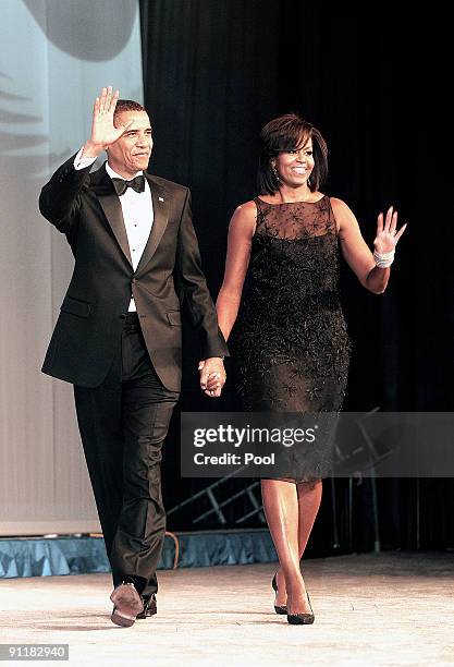 President Barack Obama and the first lady Michelle Obama attend the Congressional Black Caucus Foundation's Annual Phoenix Awards Dinner at the...