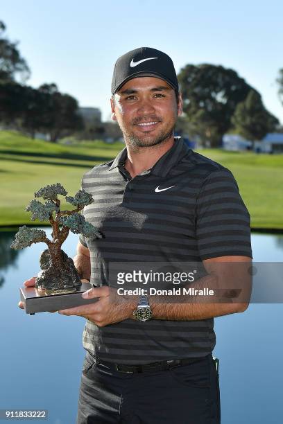 Jason Day of Australia poses with the trophy after the sixth playoff on the 18th hole to win the Farmers Insurance Open at Torrey Pines South on...