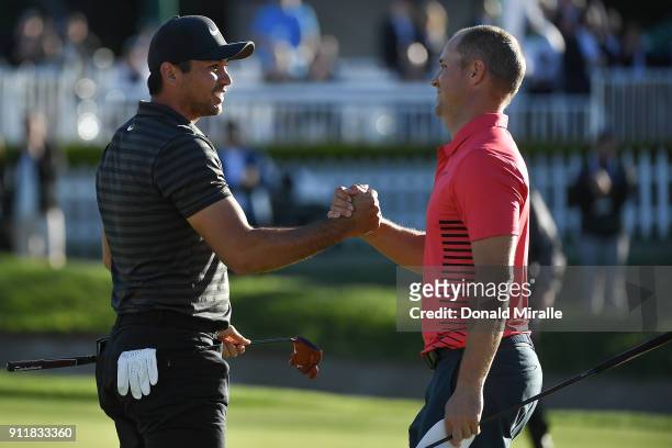 Jason Day of Australia shakes hands with Alex Noren of Sweden on the sixth playoff on the 18th green after winning the Farmers Insurance Open at...