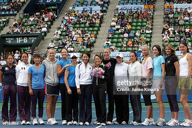 Ai Sugiyama of Japan poses with fellow players during a special ceremony on day one of the Toray Pan Pacific Open Tennis tournament at Ariake...