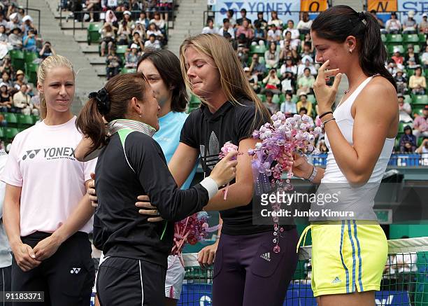 Ai Sugiyama of Japan is greeted by fellow players during a special ceremony on day one of the Toray Pan Pacific Open Tennis tournament at Ariake...