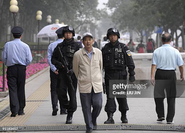 China-politics-60years-anniversary BY MARINANNE BARRIAUX Chinese special forces policemen patrol along Chang'an Avenue near Tiananmen Square in...