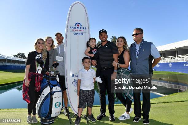 Jason Day of Australia poses with his wife, Ellie Day, his children, Dash and Lucy, and his caddie, Rika Batibasaga, after winning the Farmers...