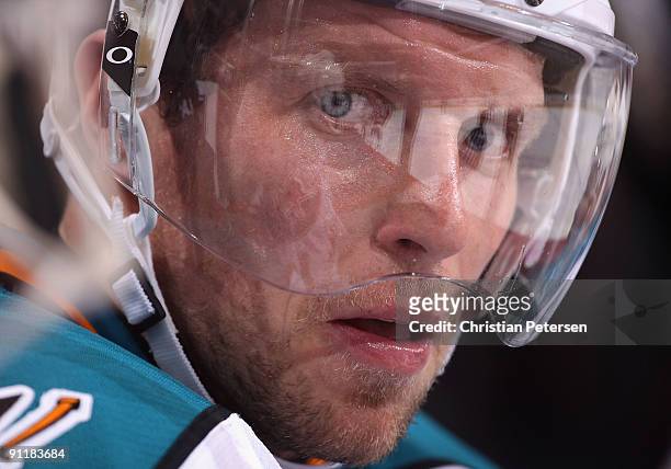Dany Heatley of the San Jose Sharks watches from the bench during the preseason NHL game against the Phoenix Coyotes at Jobing.com Arena on September...